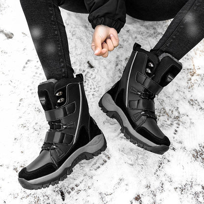 HexoComfy™ high-top winter boots in Black with hook-and-loop straps on a snowy path